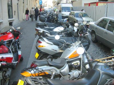 Motorcycle parking on side street in Paris.